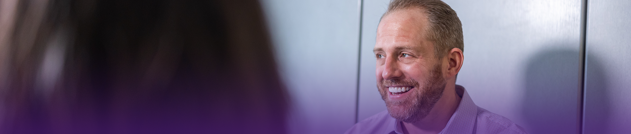 Doctor Steve smiling while talking to a patient about dental implants in Keokuk