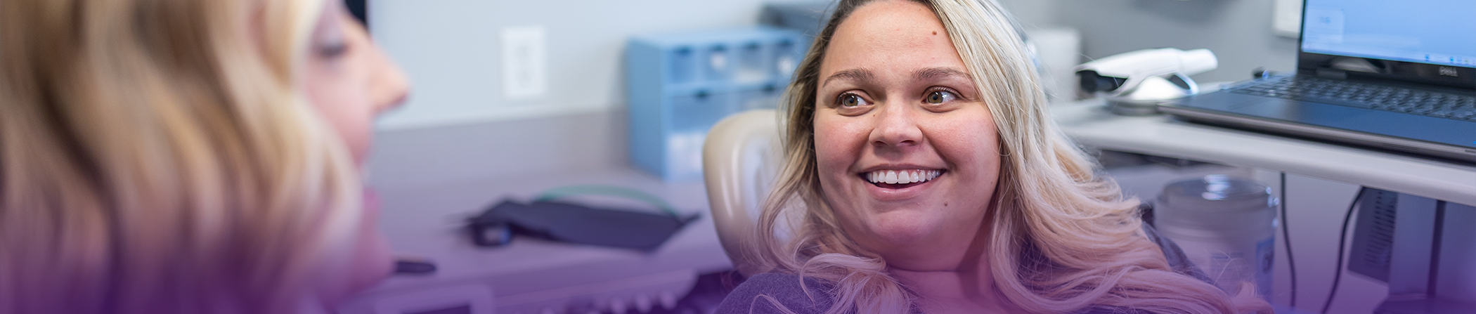 Woman listening to her dentist talk about gum disease treatment in Keokuk