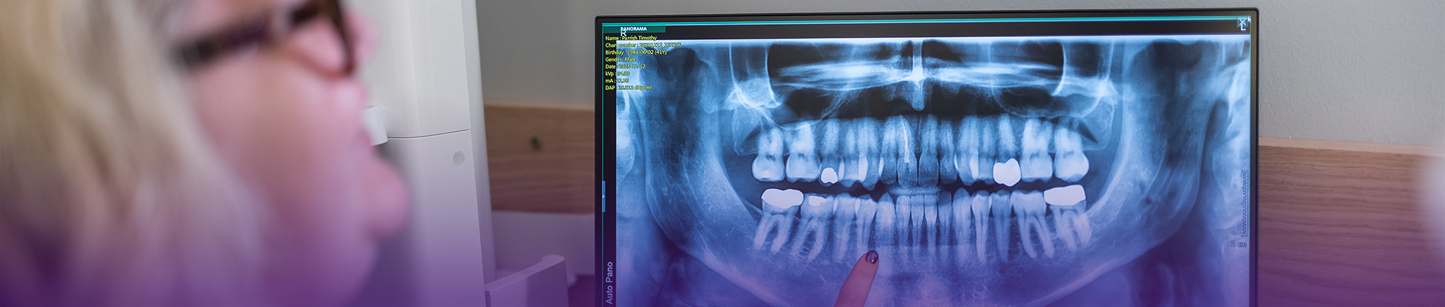 Dental patient looking at an x ray of her teeth