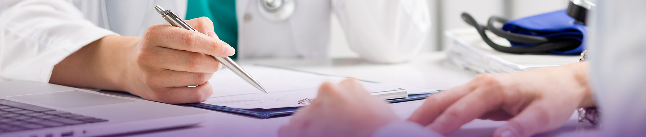 Dentist and a patient filling out paperwork at a desk