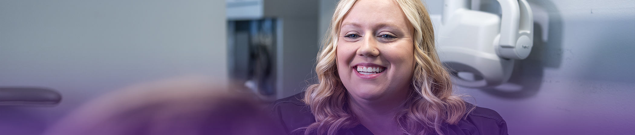 Dental team member smiling at a patient
